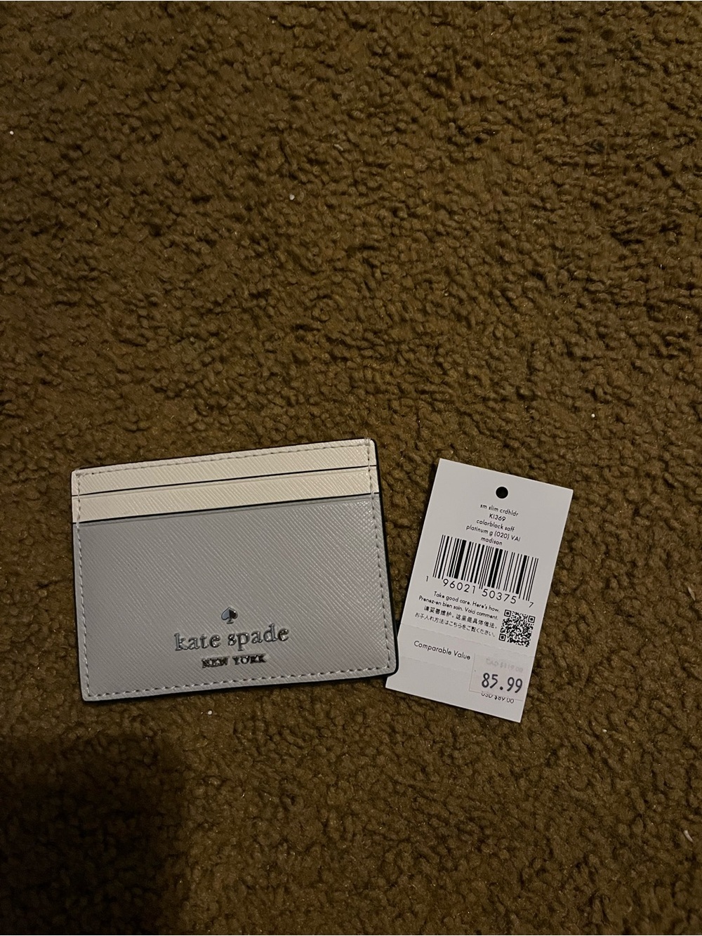 Kate Spade card holder. New. Gray.